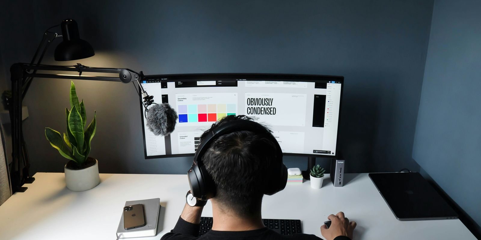 Planning at a desk: a designer at a monitor in a quiet studio