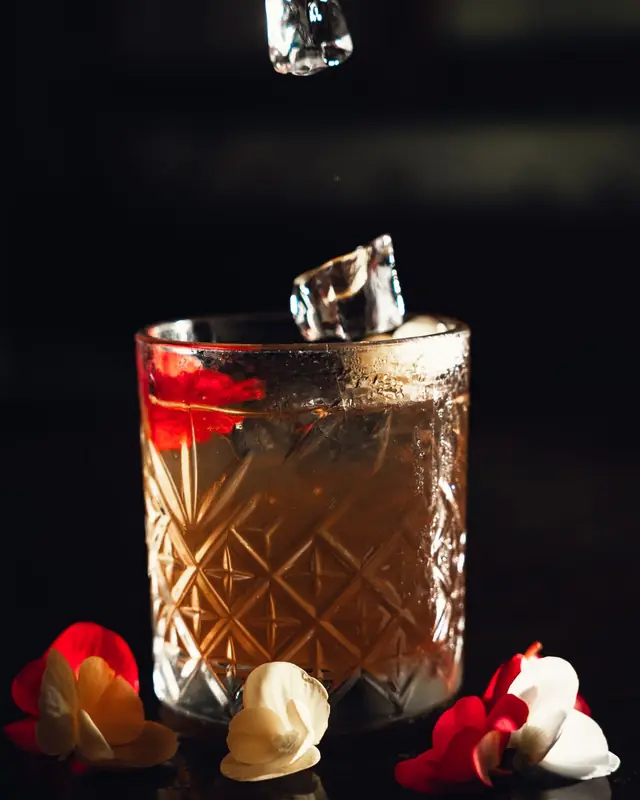 Ice falling into a cut-glass tumbler